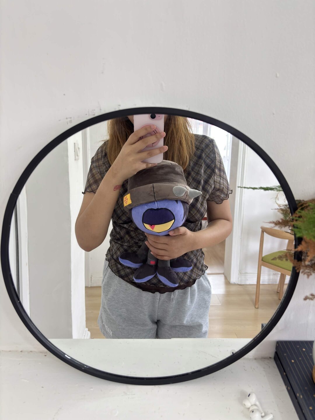 The Gloom plushie on a shelf at home
